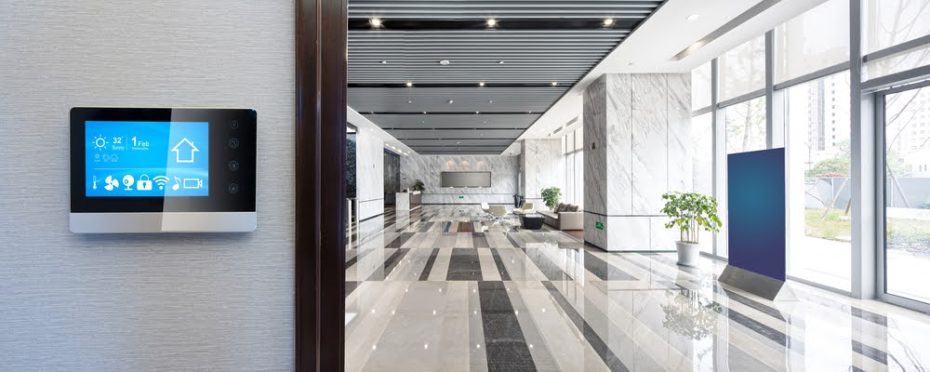 Smart device on wall leading to a large office lobby