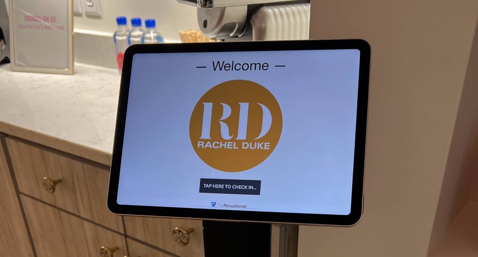 An iPad showing a screen with a logo for Rachel Duke's Injectables Boutique